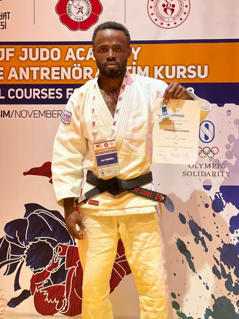 Joel Wawina receiving his certificate
